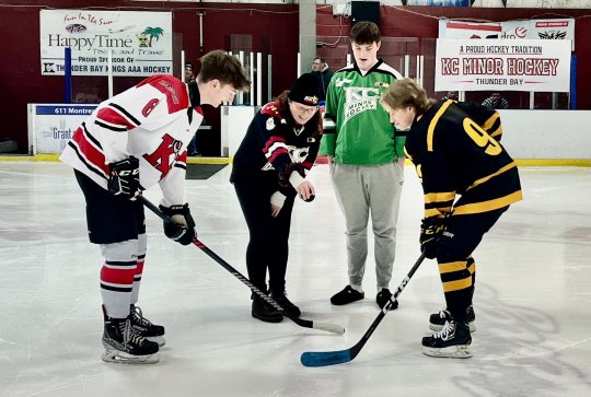 Amy Johnson and Miles Kozar line up to drop the puck between two lifelong friends of the Kozar family, Ben Wielinga and Paul Nixon